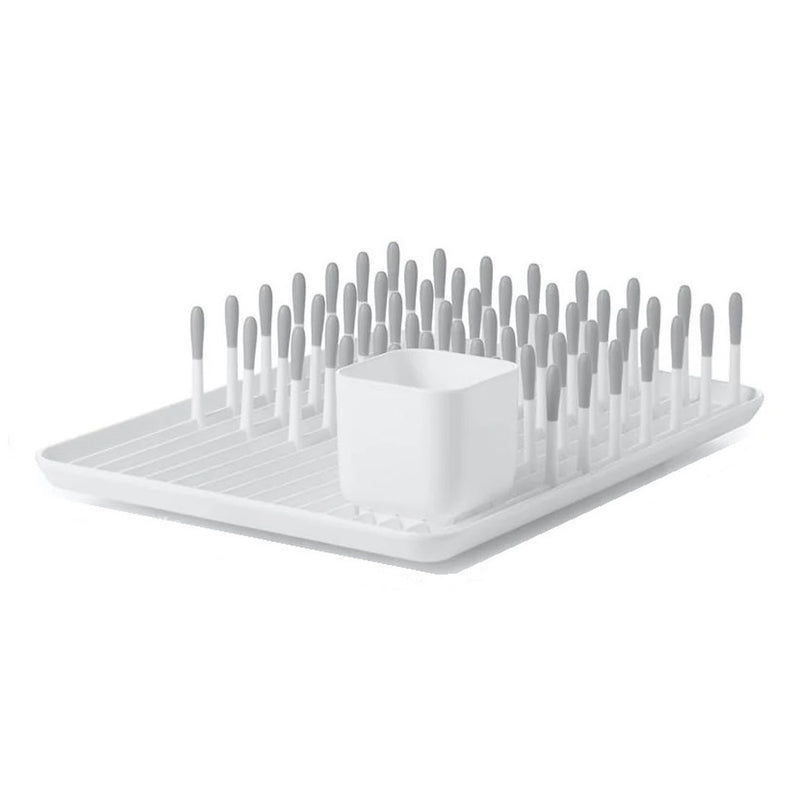The OXO Tot Bottle Drying Rack Grey by Oxo Tot features upright gray-tipped pegs and a removable cup, perfect for organizing and maximizing drying space for dishes and utensils.