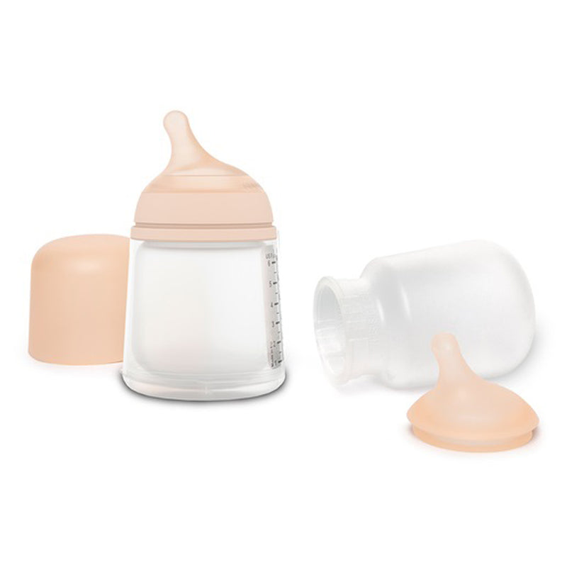 Two Suavinex Zero Zero Baby Bottle Starter Set 0M+ bottles by Suavinex are shown—one upright with its lid beside it, the other lying on its side with the nipple and cap removed. Perfect for supporting breastfeeding.