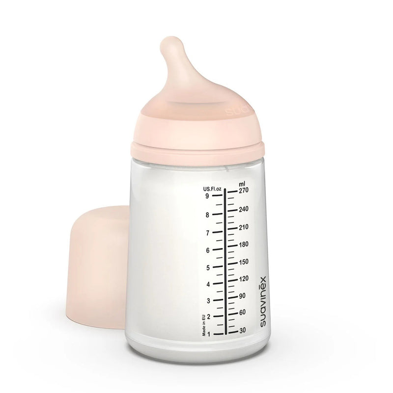 The Suavinex Zero Zero Anti Colic Bottle 270ml (Medium Flow, 3M+) features measurement markings, an anti-colic silicone nipple, a soft pink screw-on top, and a matching cap—ideal for breastfeeding moms.