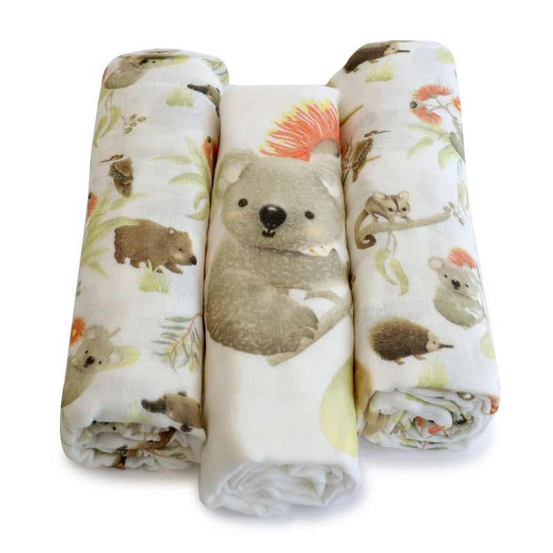 The Bubba Blue Aussie 3pk Muslin Wraps by Bubba Blue feature three lightweight swaddles with soft, earthy illustrations of bush animals like koalas and wombats. The center wrap has a large koala face design.