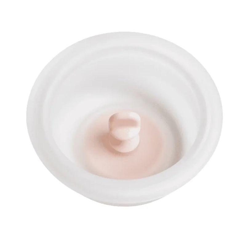 The Hegen Manual Breast Pump Diaphragm (SoftSqround) by Hegen is a white, round silicone lid with a light pink handle, perfect for replacing or updating your breast pump accessories.