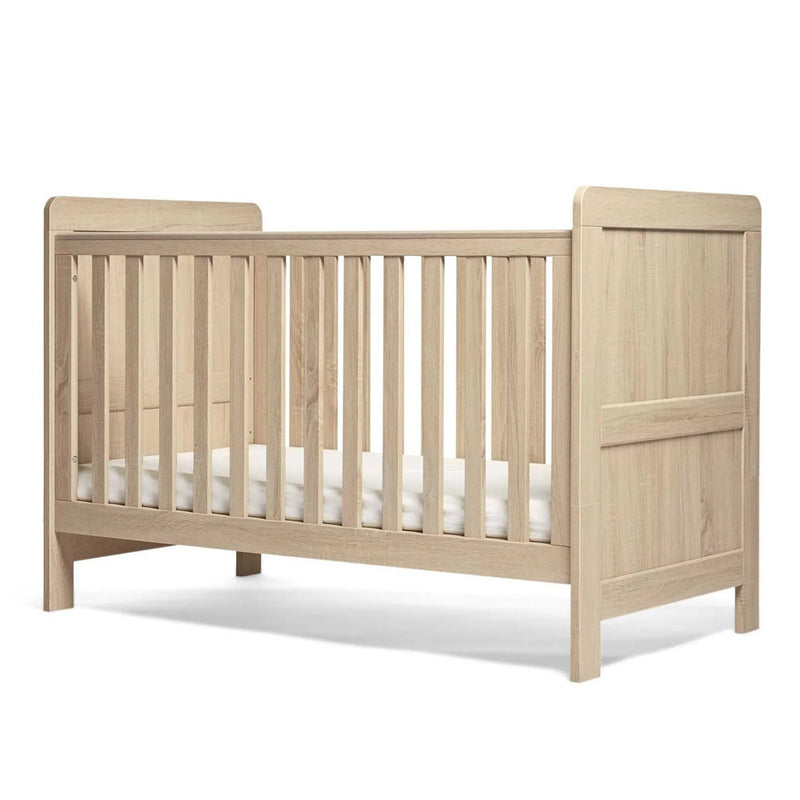 The Mamas & Papas Atlas Cot Bed by Mamas & Papas features slatted sides, teething rails, a solid headboard and footboard, and a modern design. A white mattress is included in this stylish piece of baby nursery furniture.