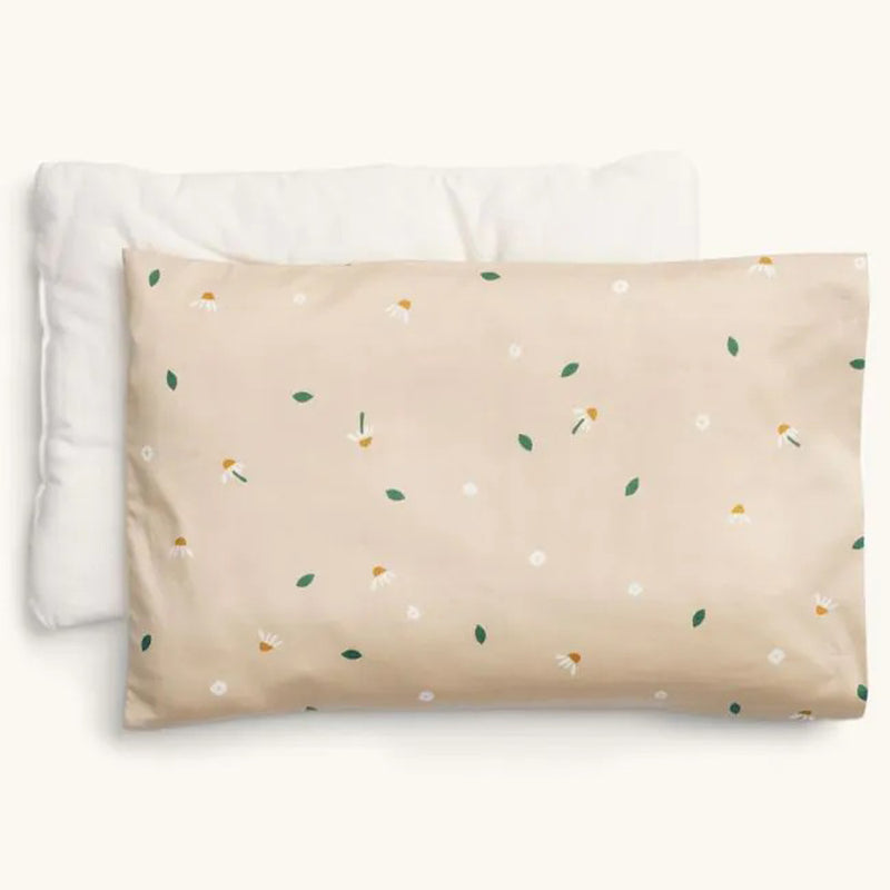 Two pillows are shown: a plain white organic toddler pillow, and the ErgoPouch Pillow With Case Daisy Sprinkle by ErgoPouch in light beige with a pattern of white flowers, yellow flower heads, and green leaves.