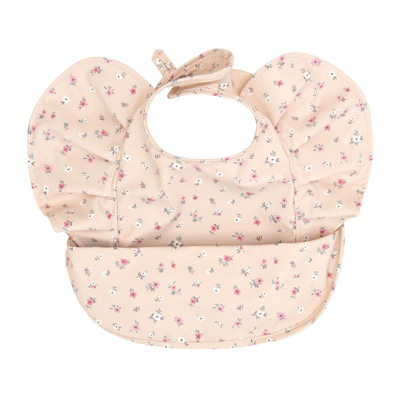The All4Ella Recycled Frills Bib flowers is a pale pink, eco-friendly bib with ruffled sleeves, a rounded pocket, and a white, pink, and purple floral pattern. It features a neck tie for fastening.