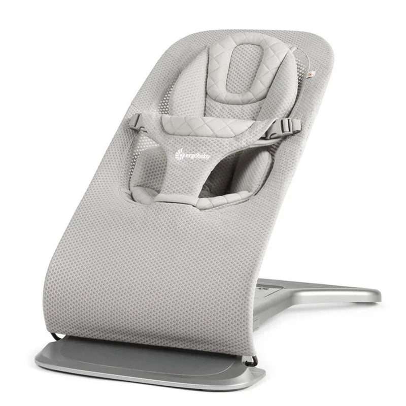 The Ergobaby Evolve Bouncer Mesh by ErgoBaby, featuring a breathable mesh fabric, adjustable harness, and curved metal frame for infants, is empty and displayed at an angle on a white background.
