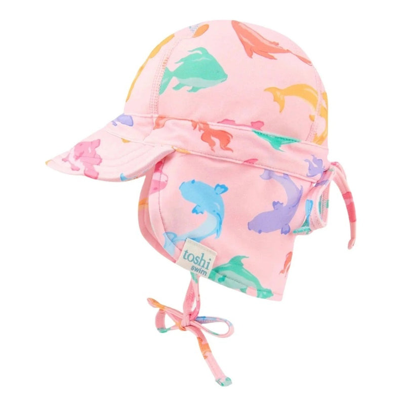 The Toshi Swim Baby Flap Cap Classic/Dishy Fishy is a pink swim cap with visor, neck flap, UPF50+ sun protection, colorful fish prints, adjustable ties, and a sewn-on "toshi swim" label.