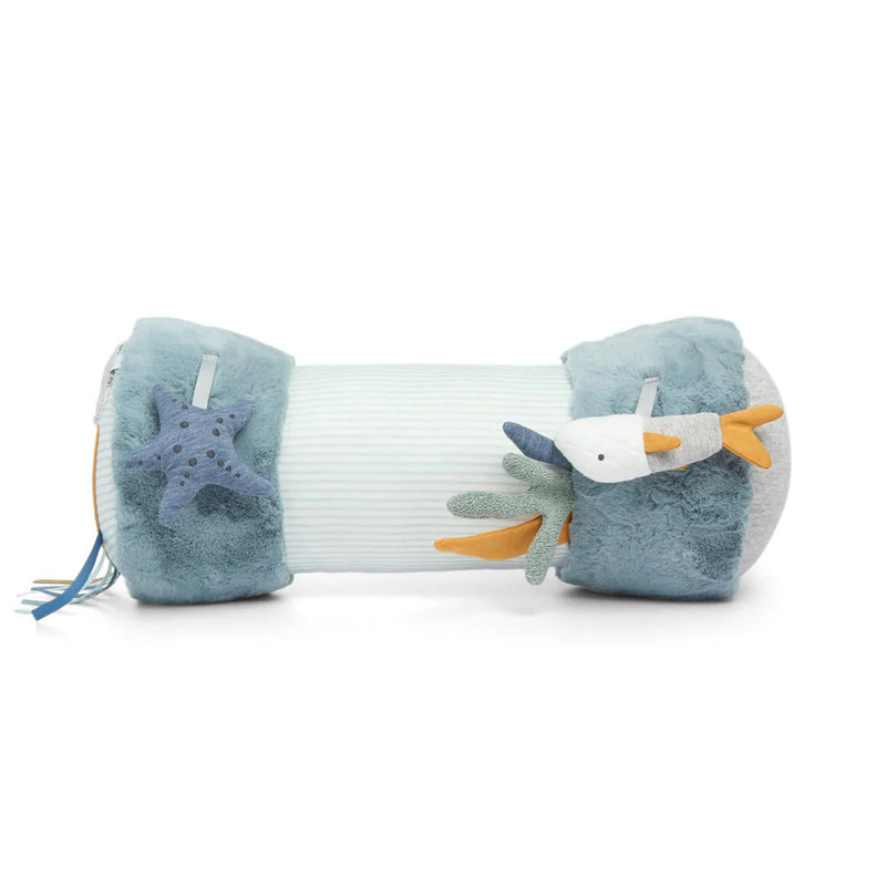 The Mamas & Papas Tummy Time Roll Blue is a soft, cylindrical pillow with plush starfish and seagull ends, textured fluffy sides, and a ribbed center to aid sensory development.