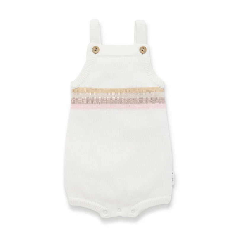 The Aster & Oak Pink Rainbow Knit Romper, made from organic cotton, features shoulder straps, two wooden buttons, tan and pink chest stripes, and bottom snaps for easy diaper changes. Sustainable babywear by Aster & Oak.