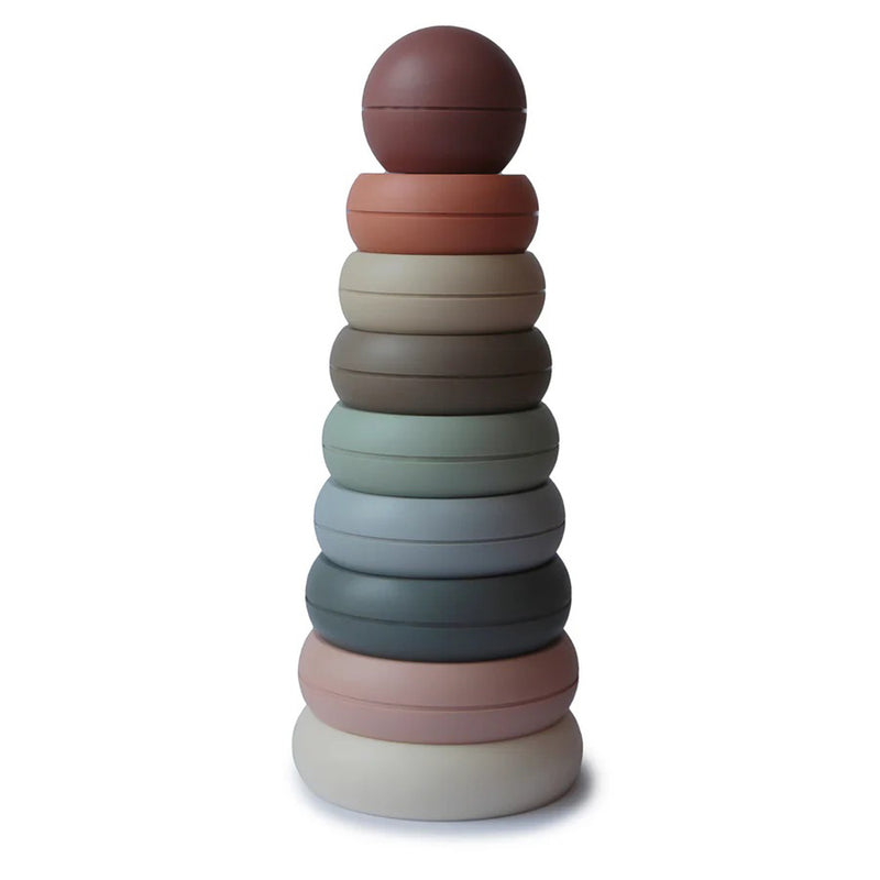 The Mushie Stacking Rings Original by Mushie is a non-toxic baby toy from the Danish Hygge collection, featuring ten muted-color, rounded rings stacked largest to smallest, topped with a solid ball and displayed against a white background.