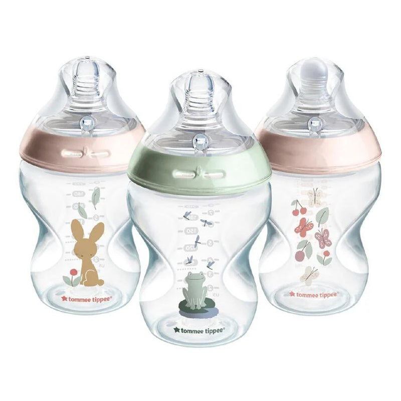 Three Tommee Tippee Natural Start 260ml bottles for girls, featuring pastel-colored lids and animal or nature-themed designs, stand upright on a white background.