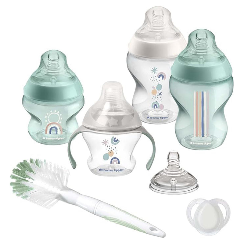 The Tommee Tippee Newborn Bottle Feeding Pack includes baby bottles in assorted sizes and designs with slow flow, breast-like teats, a bottle brush, pacifier, spare nipple, and trainer cup—all in soft pastel colors.