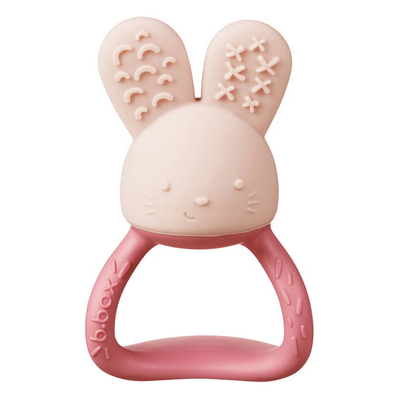 The b.box B.Box Chill + Fill Teether Blush is a pink and beige silicone teether with a bunny shape, soft textured handle, smiling face, and playful ear patterns for fun sensory play.