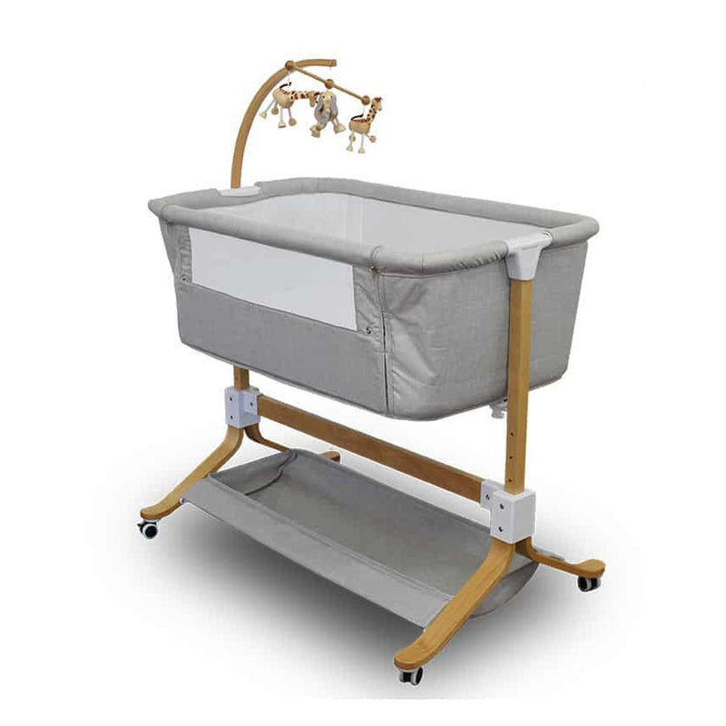 The Babyhood Kaylula Co Sleeper Cradle by Babyhood features a modern gray design, wooden legs, white accents, mesh window, lower storage shelf, plush animal mobile, adjustable dropside, and wheels for easy mobility and access.