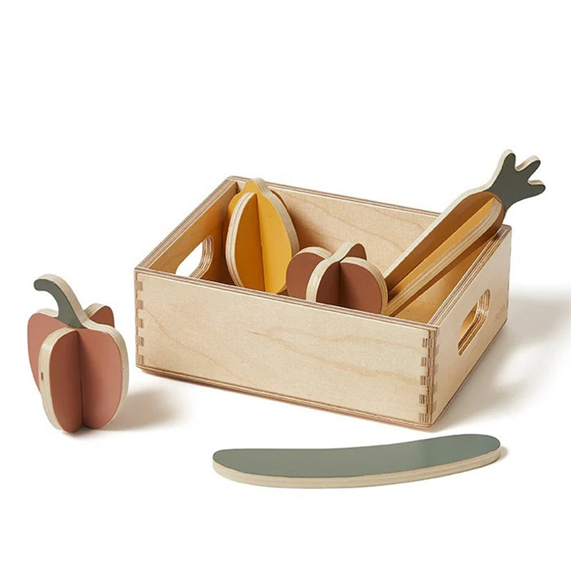 The Flexa Vegetables Wooden Play Set by Flexa features a wooden crate with toy vegetables—eggplant, pepper, carrot, and cucumber—in muted natural colors. Great for pretend play or learning, with one pepper displayed outside the crate.