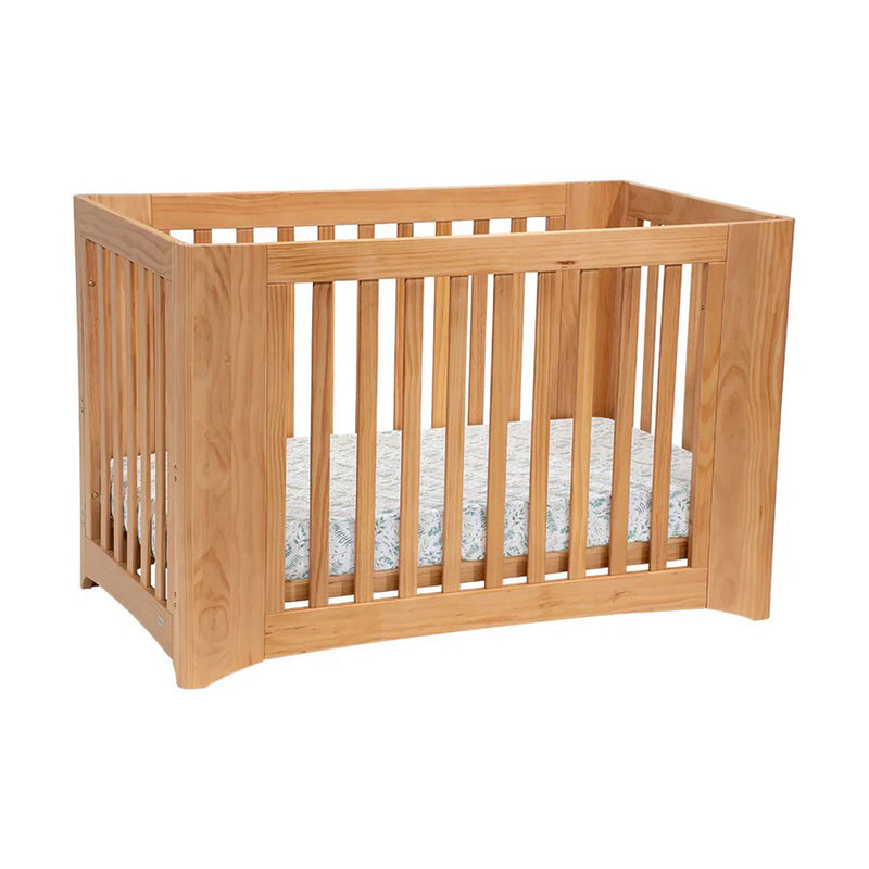 The Cocoon Evolve 4in1 Sandstone [BUNDLE] ONLY by Cocoon is a versatile wooden cot with vertical slats and a light mattress, ideal nursery furniture, shown on a plain white background.