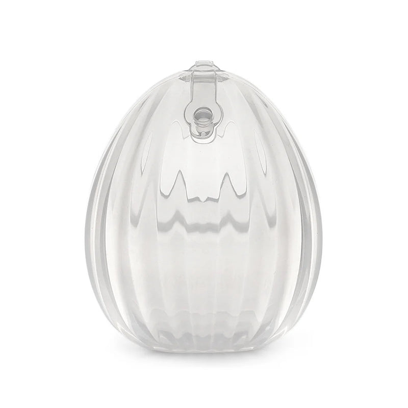 The Haakaa Shell Wearable Silicone Breast Pump by Haakaa is a clear, oval-shaped milk collector featuring a vertical ridge pattern and a small circular latch at the top center.