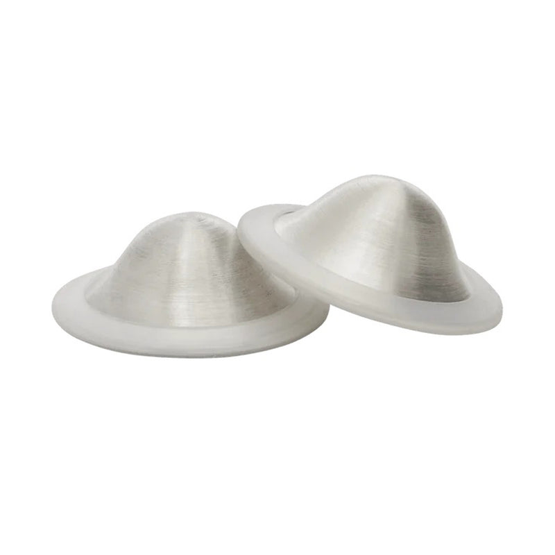 The New Beginnings Silver Nursing Cups by New Beginnings are two translucent silicone domes with flat circular bases, shown side by side on a white background—perfect for soothing sore nipples during breastfeeding.