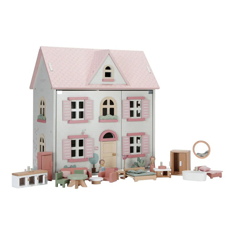 The Little Dutch Wooden Doll House Medium Essentials is a pink and white three-story toy house with miniature furniture—chairs, sofas, bed, wardrobe, kitchen set, and bathtub—all neatly arranged in front.