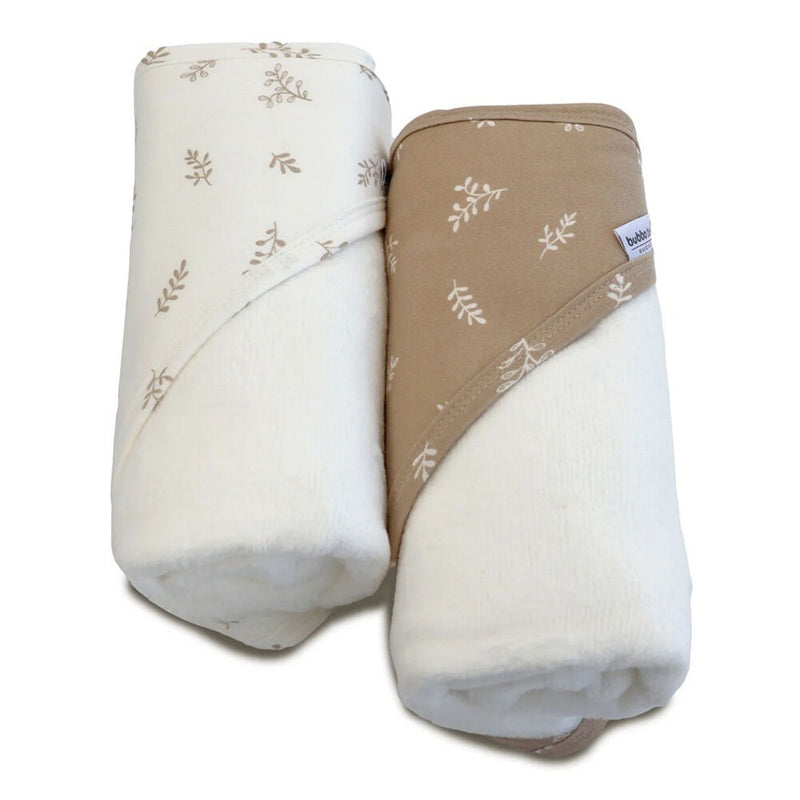 Two Bubba Blue Organic Chestnut 2pk Hooded Towels, one white with light brown leaf patterns and the other light brown with white leaves, lay side by side—soft, plush, and absorbent for your baby.