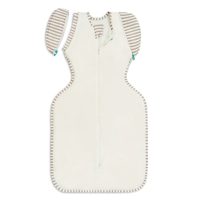 The Love To Dream Transition Bag 1.0T Organic Cotton in Cream, by Love To Dream, features gray and white striped trim and detachable wing sleeves; ideal as a swaddle transition bag for your baby.