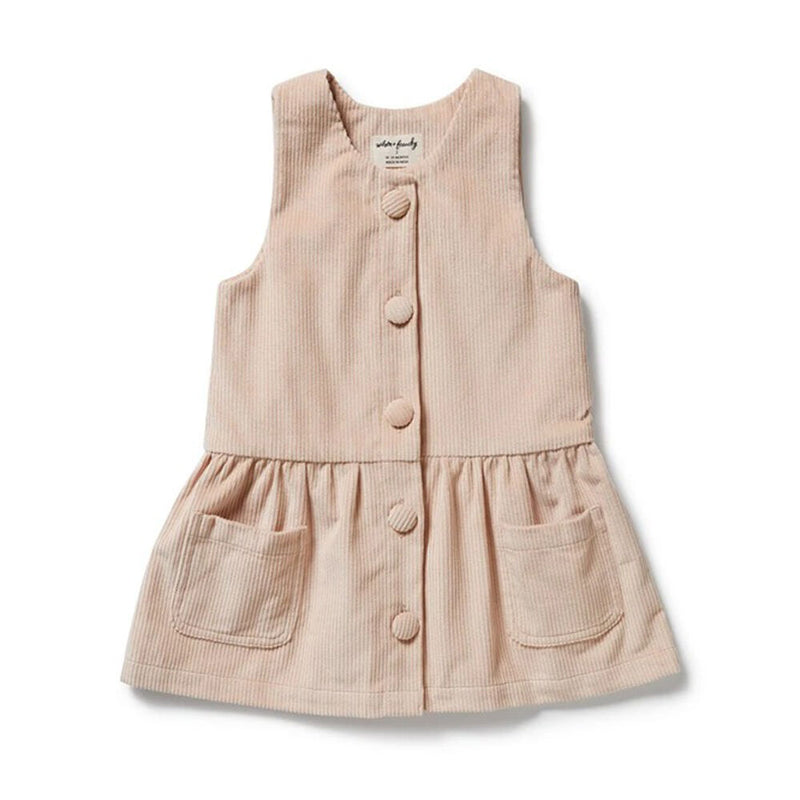 The Wilson & Frenchy Rose Organic Cord Dress by Wilson & Frenchy is a sleeveless, light beige toddler dress with adjustable straps, large front buttons, two pockets, and a ruffled skirt, shown laid flat on a white background.