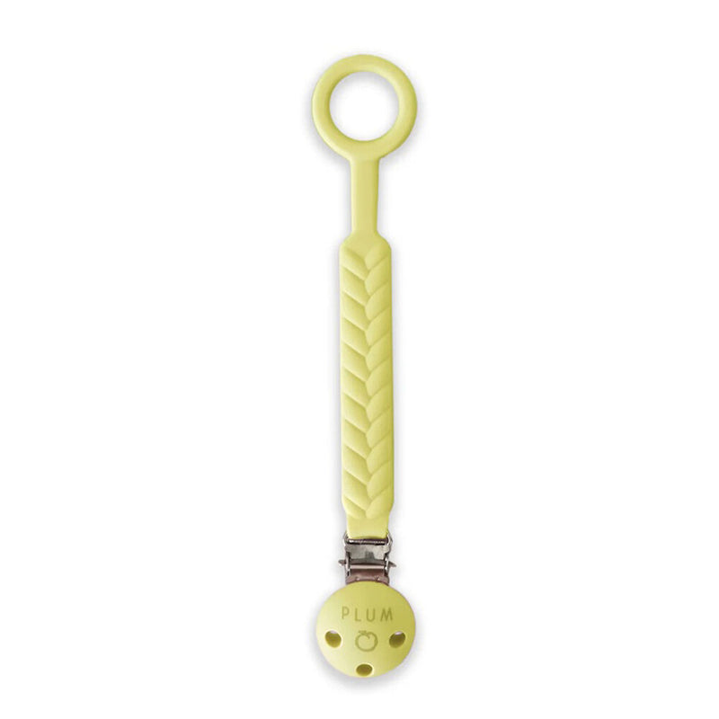 The Plum Sorbet Soother Connector by Plum is a light yellow silicone pacifier holder with a braided design, round clasp engraved with "PLUM," and a loop for attaching soothers.