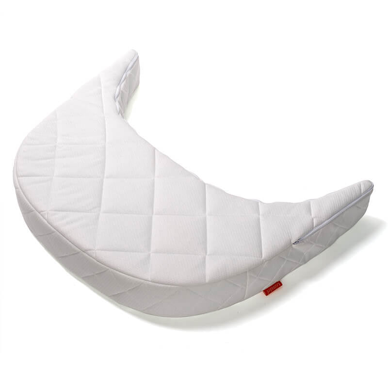 A crescent-shaped, quilted white cushion by Leander, photographed on a white background—perfect as the Leander Junior Bed Extension Mattress or to complement your cold foam mattress.