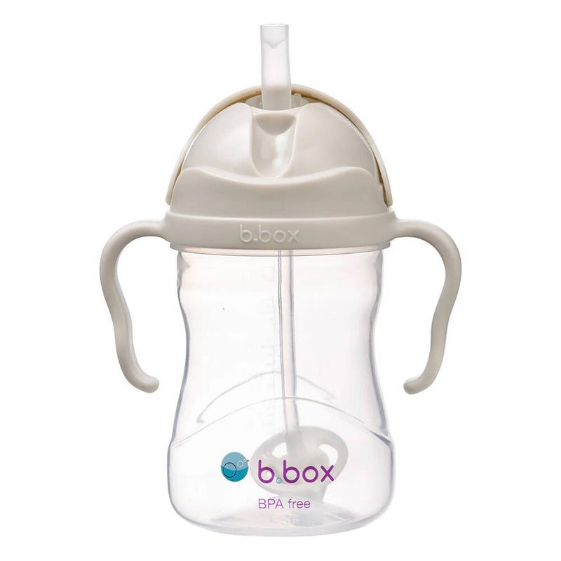 The B.Box Sippy Cup by b.box features beige handles and lid, a weighted straw for easy sipping, and "b.box" branding in purple and blue. BPA free and ideal as a baby’s first drinking cup.