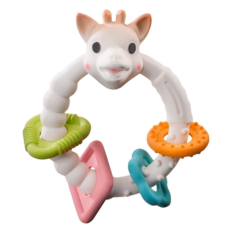The Sophie La Girafe Teething Colo'rings by Sophie is a white giraffe head teether with four textured, colorful rings—green, orange, pink, and blue—around the handle to help soothe baby's sore gums.