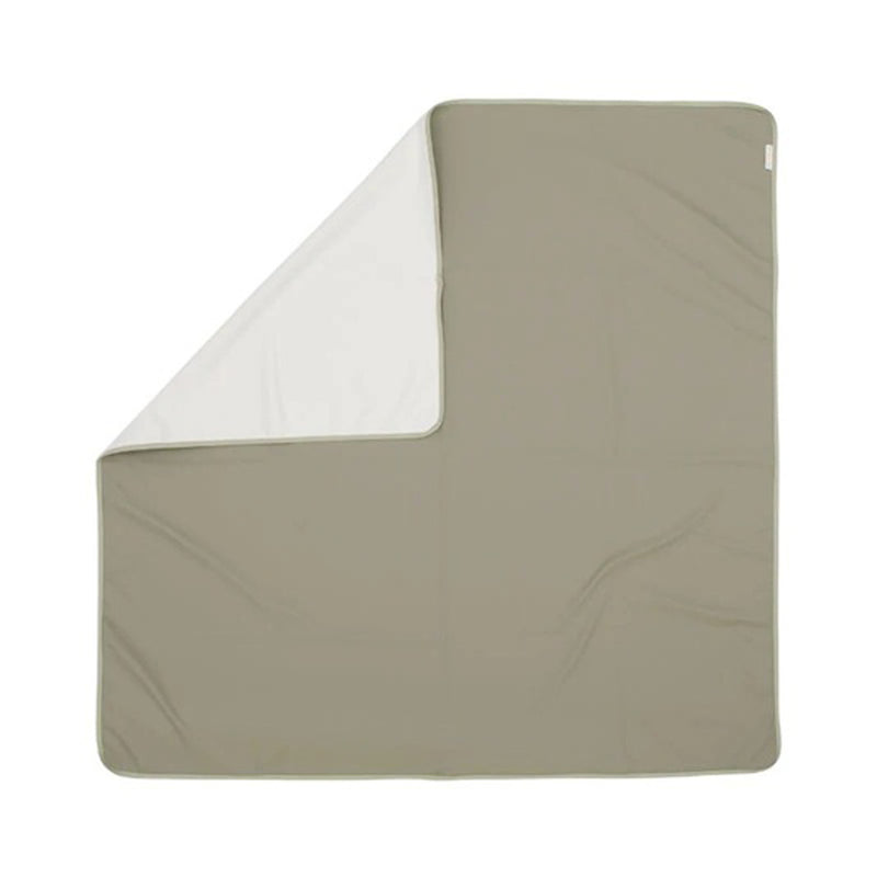The All4Ella Recycled Messy Mat Sage, an eco-friendly rectangular mat by All4Ella, features a light beige top and white underside, displayed flat with a corner folded to show both colors.