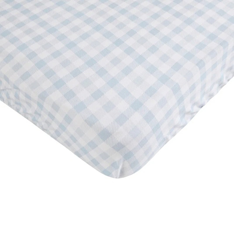 The All4Ella Waterproof Fitted Cot Sheet Gingham Blue features a light blue and white plaid pattern and is shown covering the corner of a mattress.