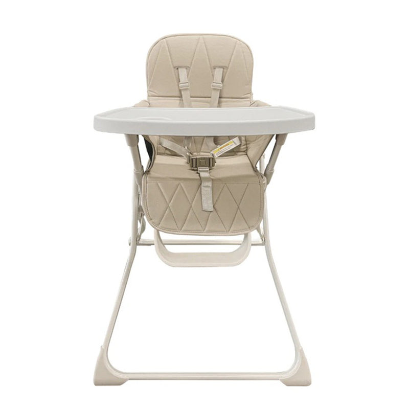 The Baby Studio Super Slim Flat Fold High Chair by Baby Studio, shown in beige with a cushioned seat, safety harness, and detachable tray on a white background, offers a space-saving design and sturdy metal frame—ideal for feeding infants or toddlers.
