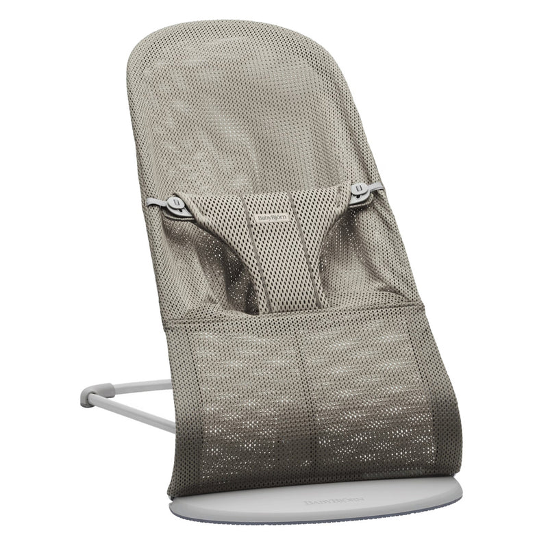 The BabyBjorn Bouncer Bliss Air Mesh features breathable grey mesh, an ergonomic design for comfort and support, a safety harness, minimalist metal frame, and folds easily for storage or travel.