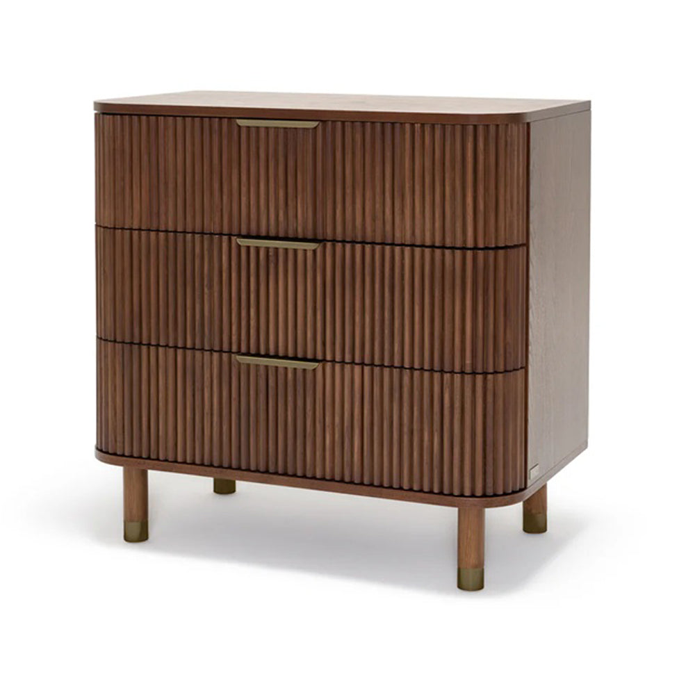 The BabyRest Juno Chest 3 Drawer Luxe Walnut features solid timber, three drawers with vertical grooves, gold-colored handles, and cylindrical legs with gold accents—all set against a white background.