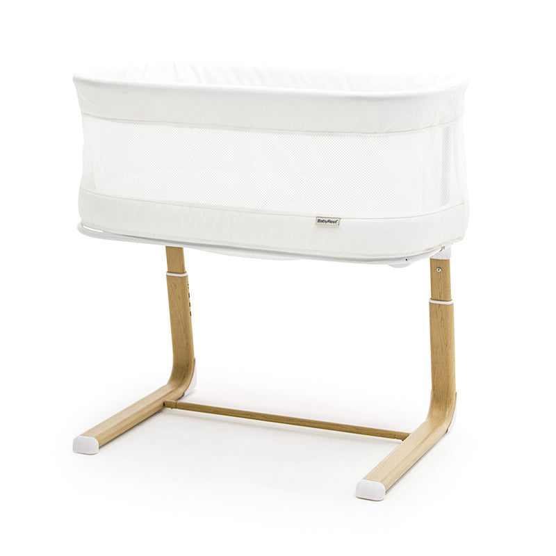 The BabyRest Swan Smart Electric Bassinet by BabyRest features breathable mesh sides, a rectangular shape, light wood legs, and a minimalist base with white foot covers—combining safety and modern style for your nursery.