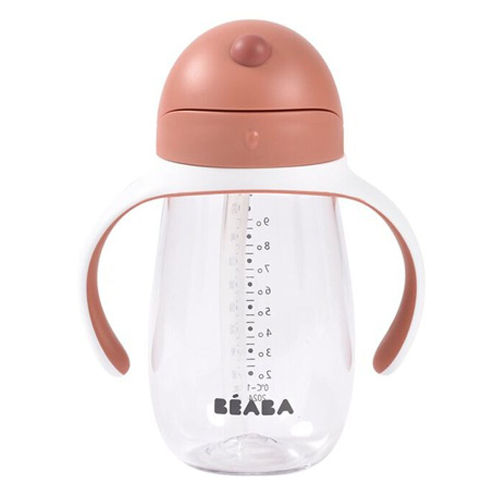 The Beaba Straw Cup 300ml is a clear toddler cup with two large curved handles, a pinkish-brown lid, measurement markings, the BEABA logo on the front, and a leak-proof design for worry-free sipping.