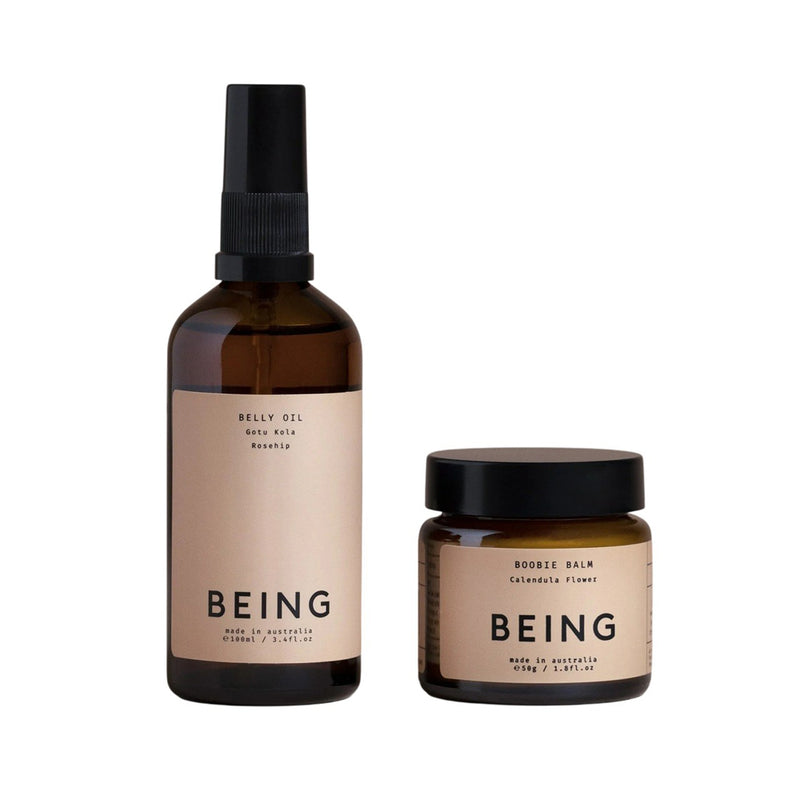 The Being Skincare Maternity Journey Set includes two amber glass containers—a spray bottle labeled "BELLY OIL" and a small jar labeled "BOOBIE BALM"—gentle essentials to nourish and care for your skin.