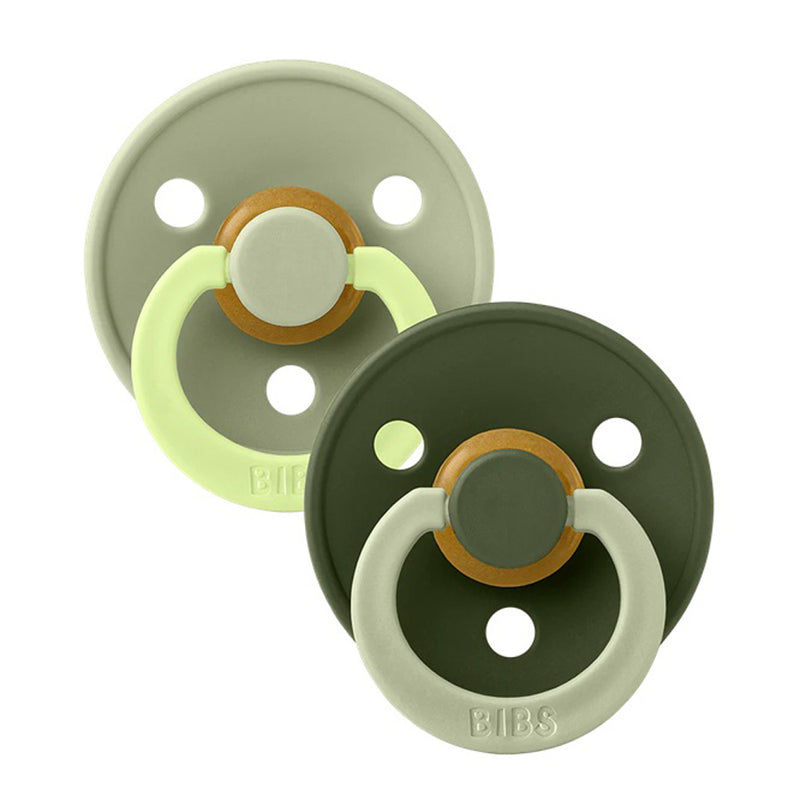 The Bibs Dummies Fusion Colour Sage Hunter Green Mix includes two BPA-free pacifiers in light sage and dark olive, featuring circular handles and "Bibs Dummies" branding. Made with natural rubber latex for safety and comfort.