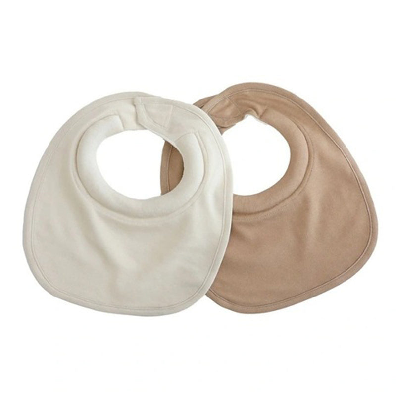 Two Bubba Blue Bubba Sundae 2PK Dribble Bibs are displayed, one off-white and one light brown, lying flat and slightly overlapping on a white background.