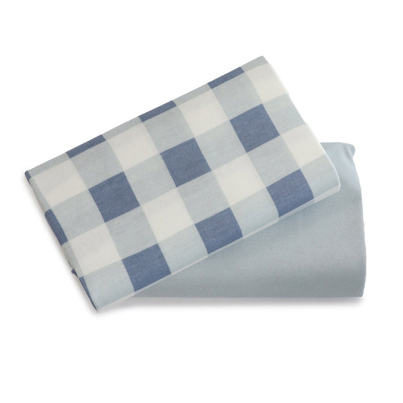 Two Bubba Blue Bubba Sundae 2PK Jersey Bedside Sleeper Fitted Sheets—one blue and white checkered, one solid light blue—are shown on a white background. Perfect for nursery bedding.