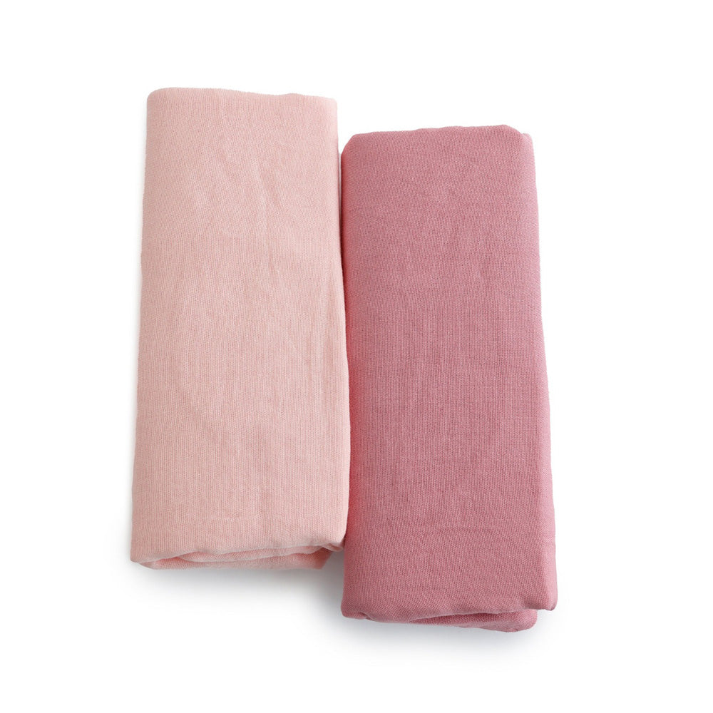Two folded fabric pieces, one light pink and one darker pink, are displayed side by side on a white background—perfect as Bubba Blue Bubba Sundae 2PK Muslin Wraps for cozy baby swaddling.