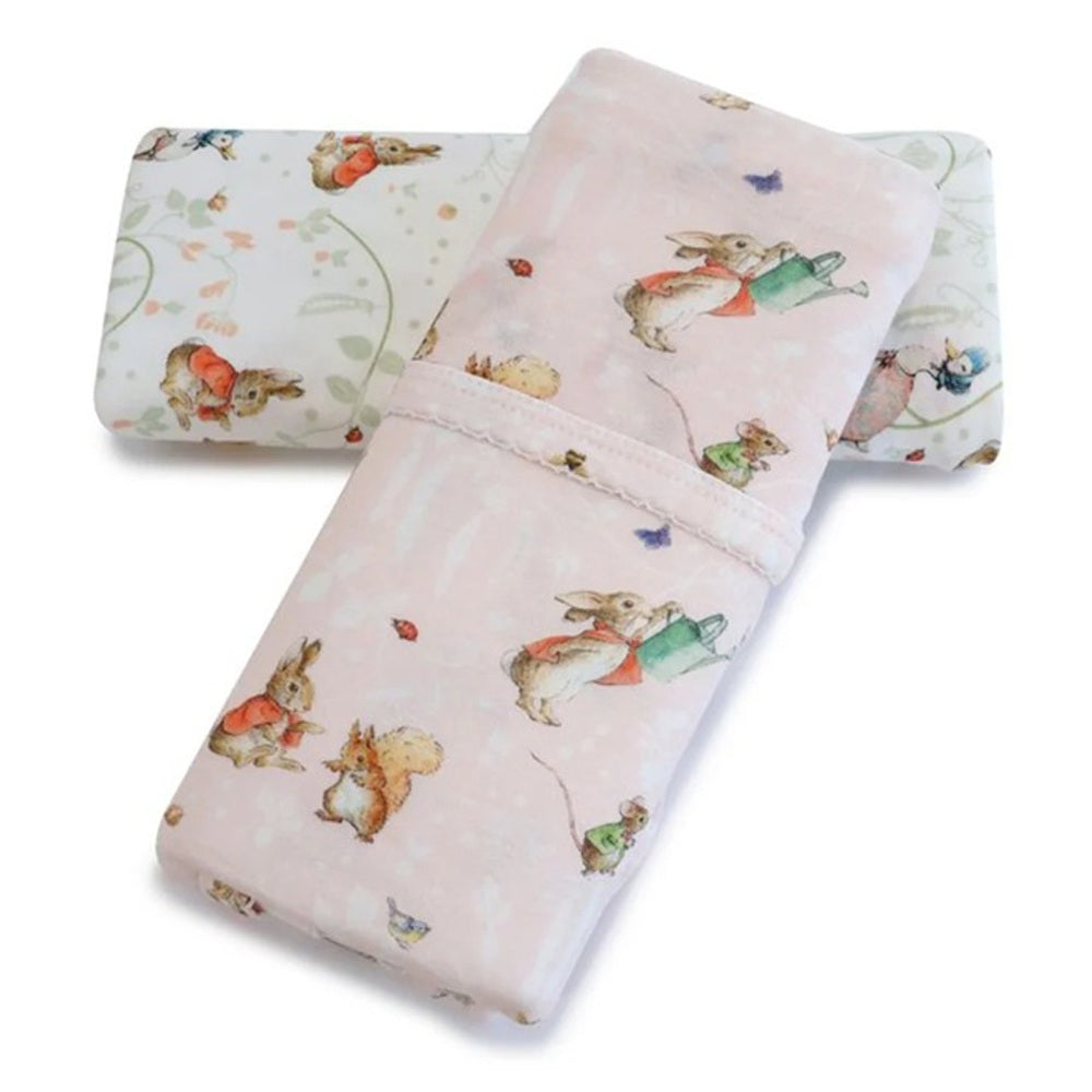 The Bubba Blue Flopsy Mopsy & Cottontail 2PK Jersey Wraps feature pastel pink and white swaddles with floral details and storybook-inspired animals, made from soft bamboo rayon jersey.