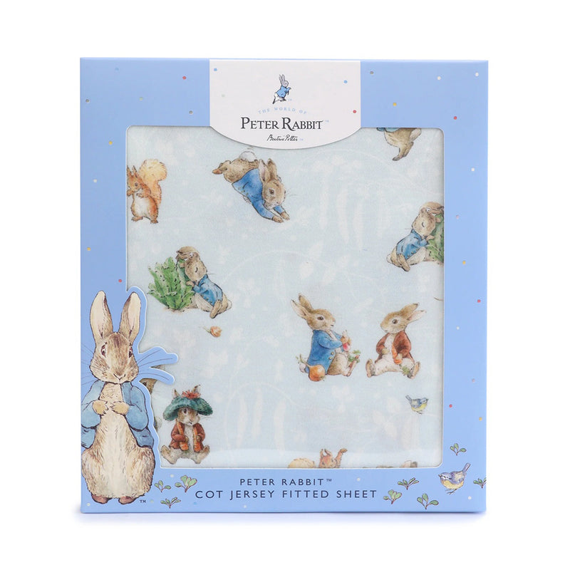 The Bubba Blue Peter Rabbit & Benjamin Bunny Cot Fitted Sheet is crafted from soft jersey and features charming Peter Rabbit and friends illustrations. It comes in light blue packaging with white details and a large Peter Rabbit image on the bottom left.