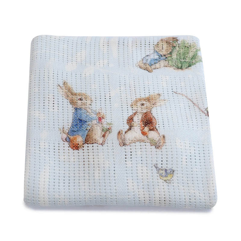 The Bubba Blue Peter Rabbit & Benjamin Bunny Digital Print Cellular Blanket is a light blue bamboo cotton baby blanket featuring rabbits in clothing, charming grass, and a bird, inspired by Beatrix Potter.