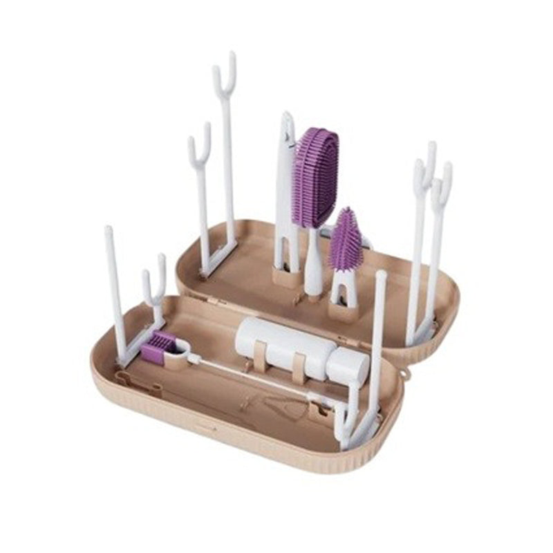 The Bubka Clean & Dry Kit by Bubka is a beige two-part plastic organizer that acts as a portable drying rack, holding cleaning brushes and utensils—some with purple bristles. Vertical pegs and slots keep items upright and separated within the tray.