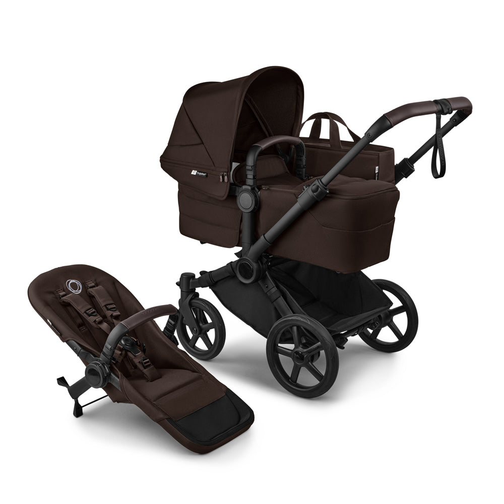 The Bugaboo Donkey 6 Pram is a black convertible stroller by Bugaboo, featuring a detachable bassinet, four large wheels, an adjustable handle, and a separate seat attachment placed beside it.