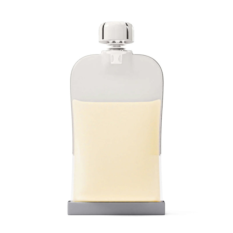 A clear, rectangular Cherub Baby Reusable Silicone Breast Milk & Food Pouch (180ml) with a silver cap and cream-colored contents stands upright on a white background, reflecting the brand’s sleek, BPA-free design.