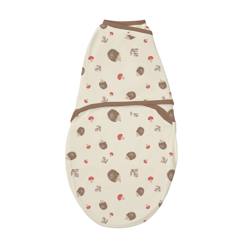 The Clevamama ClevaSleep Swaddle Hedgehog by Clevamama is a cream-colored Australian cotton swaddle with brown trim, featuring cute hedgehogs, red mushrooms, and leaves—perfect for keeping your baby cozy and comfortable.