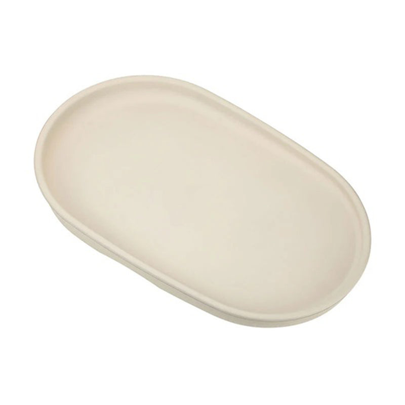 The Cocoon Comfy Change Mat by Cocoon is an oval, off-white ceramic dish seen from above on a white background—its smooth surface makes cleaning effortless.