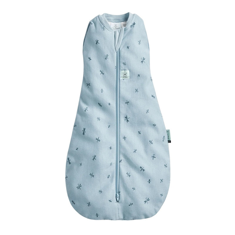 The ErgoPouch 1.0 Tog Cocoon Dragonflies by ErgoPouch is a light blue, sleeveless swaddle bag with a front zipper, soft organic cotton fabric, and a roomy rounded bottom for comfort. Features small dark blue dragonfly patterns.